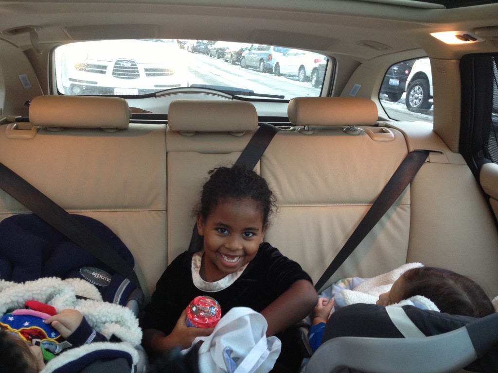 In Laurie's car. Josephine sandwiched by the twins.