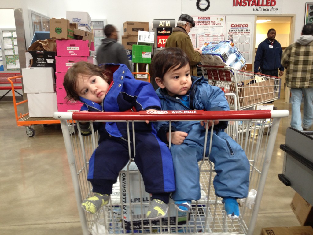 Growing up - they can sit up and fit into the Costco cart now.