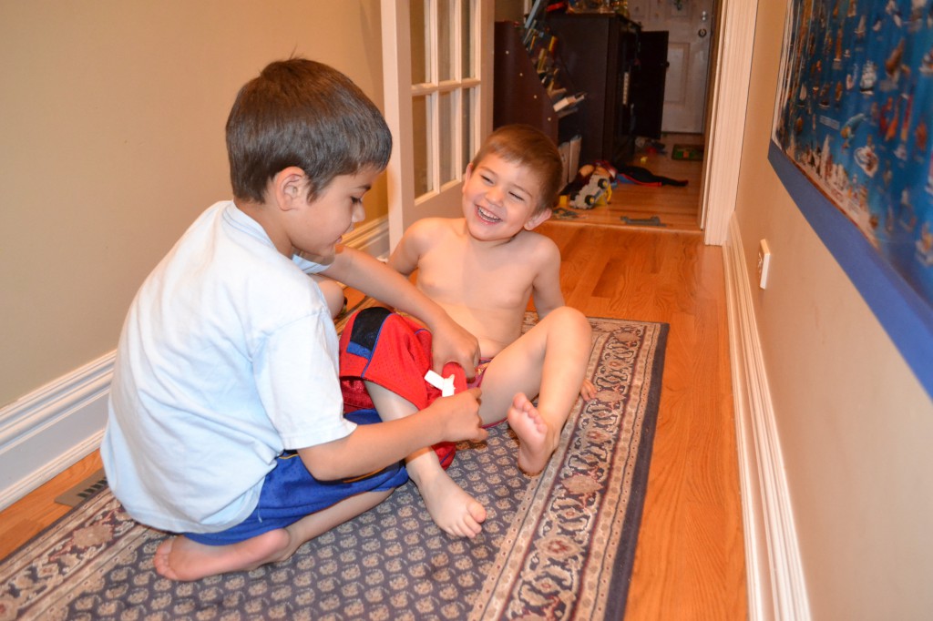 Jack helps Ben get dressed in his own clothes.