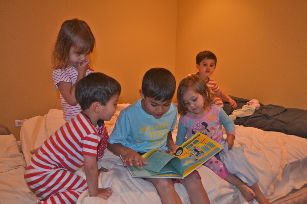 Jack reading 'Pete the Cat' to the littles.