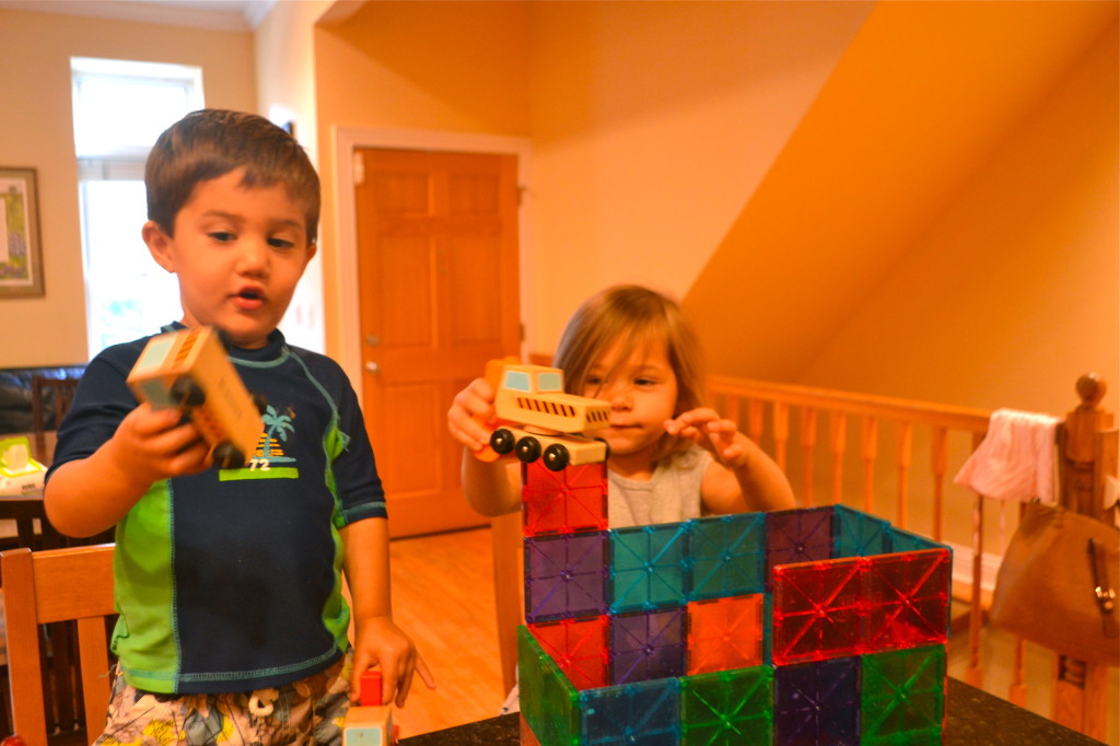 Sam and Indigo built a castle for her, then put construction vehicles in it for him.