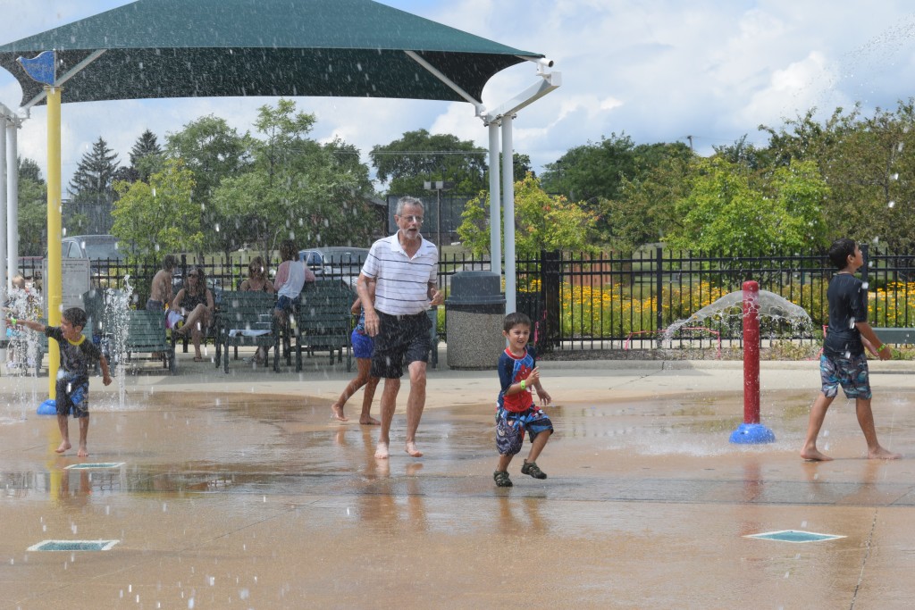 Even Grandpa gives the splash pad a whirl!