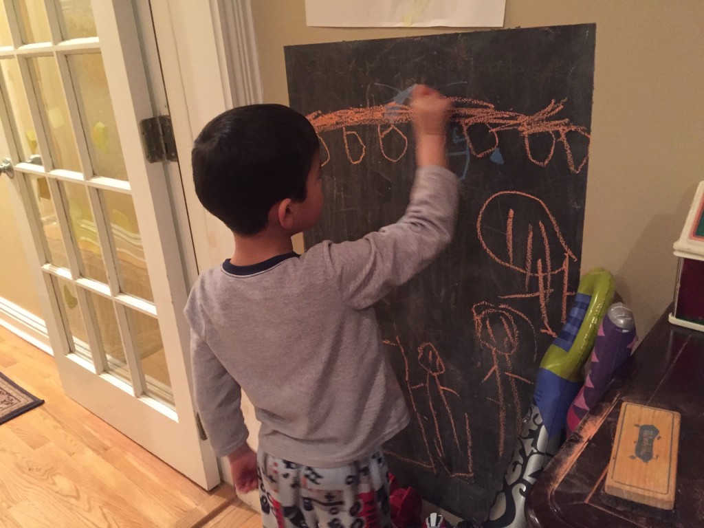 The twins rediscovered the chalk board in their room.