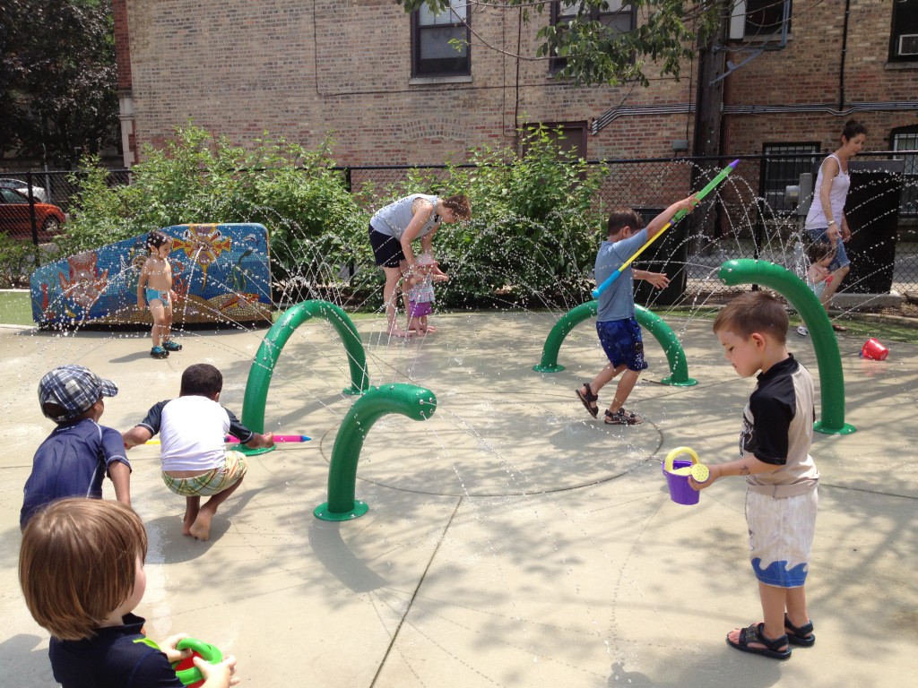 All the other boys play games together with the water squirters, Ben prefers to water the flowers. (Weisman Park)