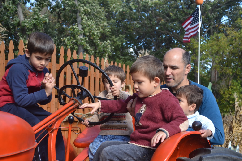 Our city boys checking out the tractor.